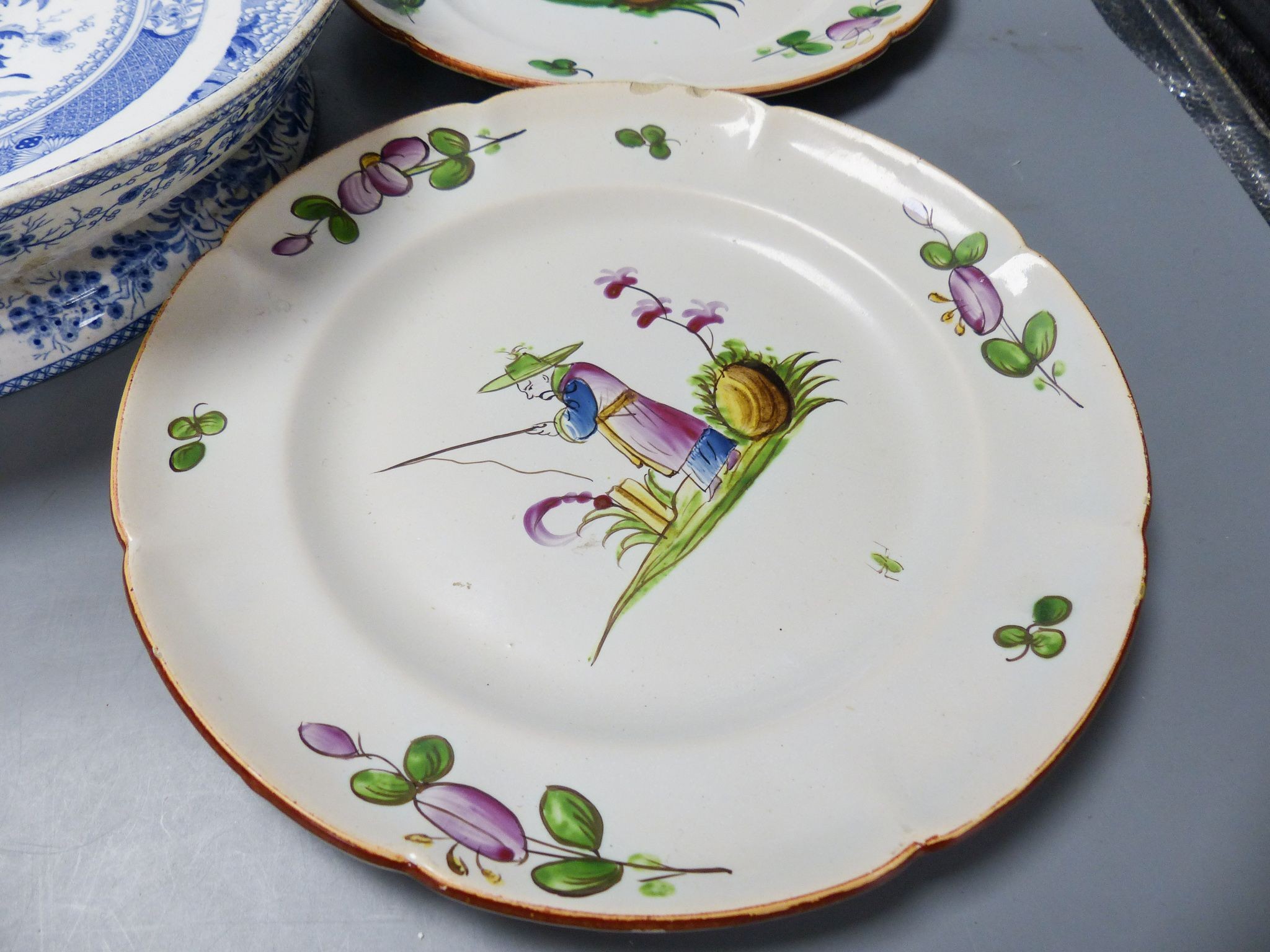 An ironstone cheese stand and a pair of French faience plates 30cm